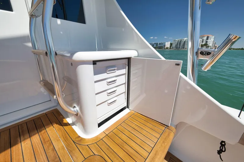 Slide: The Image of 2003 Weaver Custom Sportfish boat interior with wooden deck and storage drawers. - 37