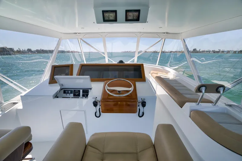 Slide: The Image of 2003 Weaver Custom Sportfish helm with ocean view, featuring modern controls and seating. - 38