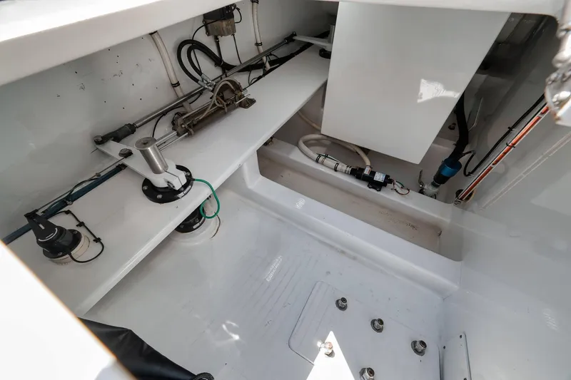 Slide: The Image of 2003 Weaver Custom Sportfish engine compartment with mechanical components and wiring. - 39