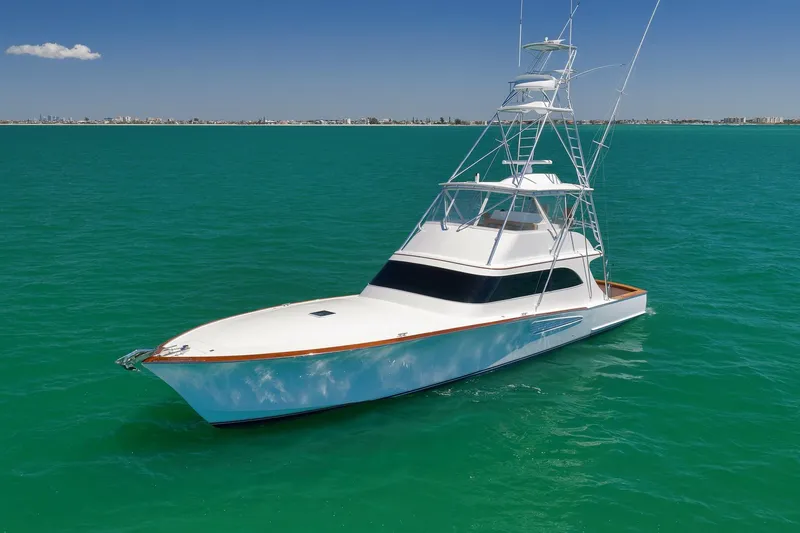Slide: The Image of 2003 Weaver Custom Sportfish yacht on turquoise water under clear blue sky. - 4