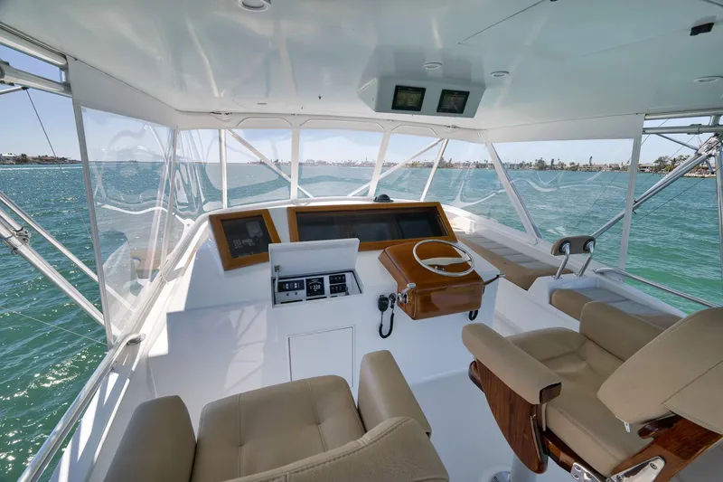 Slide: The Image of 2003 Weaver Custom Sportfish helm with dual seats, steering wheel, and ocean view. - 40