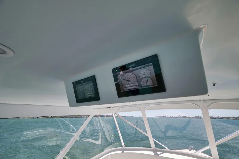 Slide: The Image of 2003 Weaver Custom Sportfish boat dashboard with ocean view and instrument panel. - 42