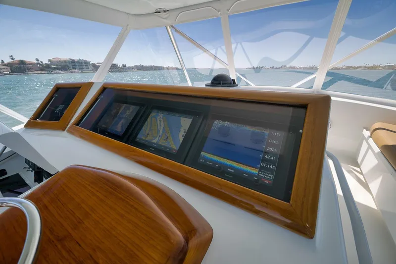 Slide: The Image of 2003 Weaver Custom Sportfish helm with advanced navigation displays and ocean view. - 43