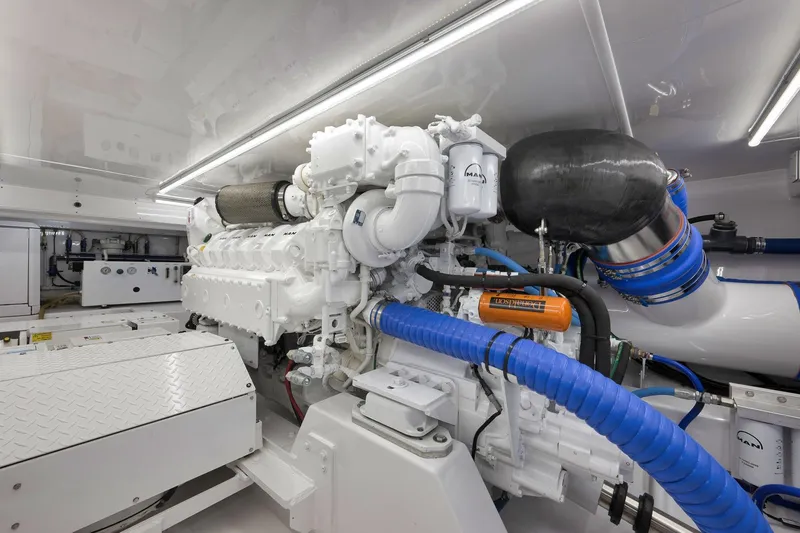 Slide: The Image of Engine room of 2003 Weaver Custom Sportfish boat, featuring advanced machinery and piping. - 48