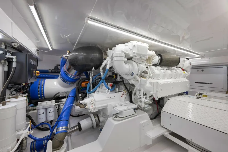 Slide: The Image of Engine room of 2003 Weaver Custom Sportfish with advanced machinery and blue piping. - 49