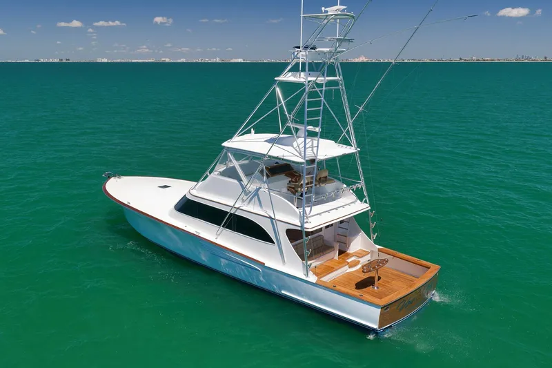 Slide: The Image of 2003 Weaver Custom Sportfish yacht cruising on turquoise waters under a clear sky. - 5