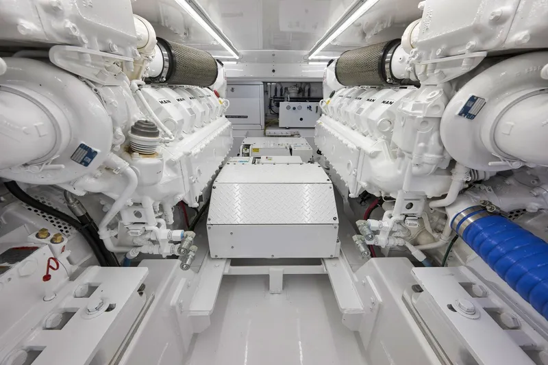 Slide: The Image of Engine room of 2003 Weaver Custom Sportfish boat, featuring dual white engines and clean layout. - 50
