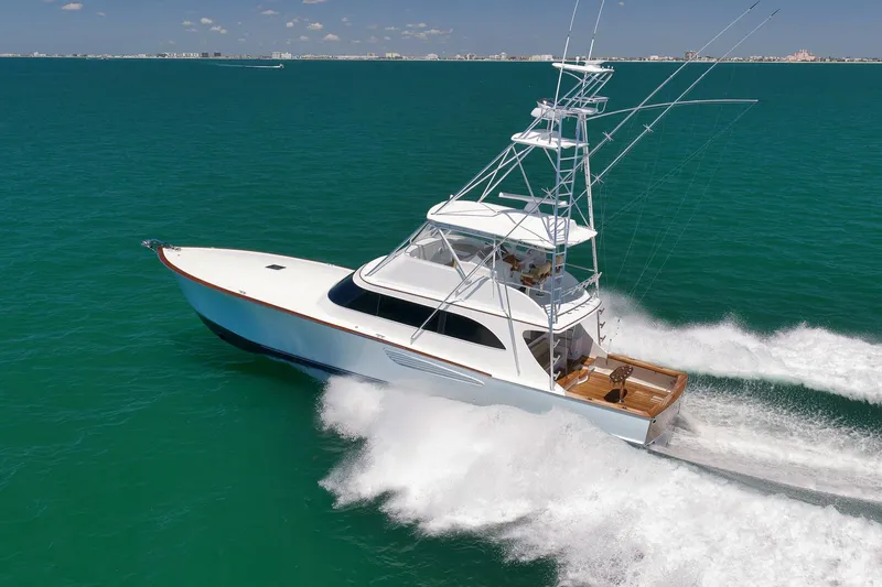 Slide: The Image of 2003 Weaver Custom Sportfish yacht cruising on open water, creating a dynamic wake. - 8