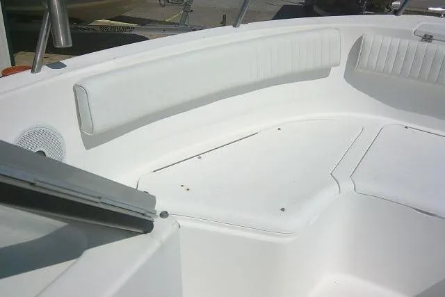 Slide: The Image of 2006 Clearwater 2200 Dual Console boat interior with white seating and storage compartments. - 10