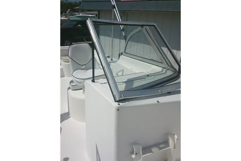 Slide: The Image of 2006 Clearwater 2200 Dual Console boat with windshield and seating, docked outdoors. - 13