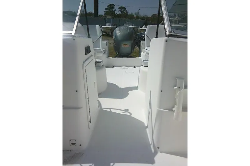 Slide: The Image of 2006 Clearwater 2200 Dual Console boat interior with seating and motor view. - 16