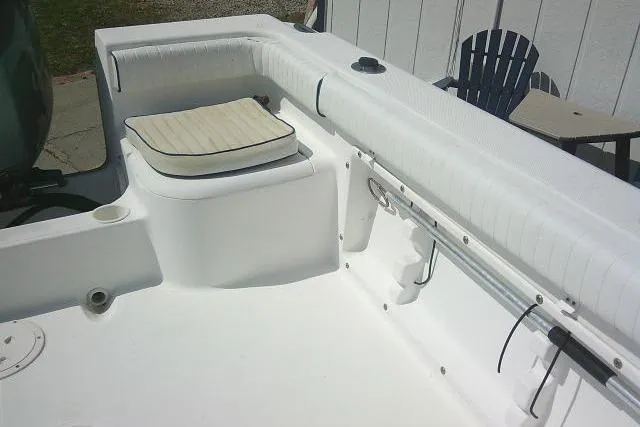 Slide: The Image of 2006 Clearwater 2200 Dual Console boat interior with cushioned seating and rod holders. - 22