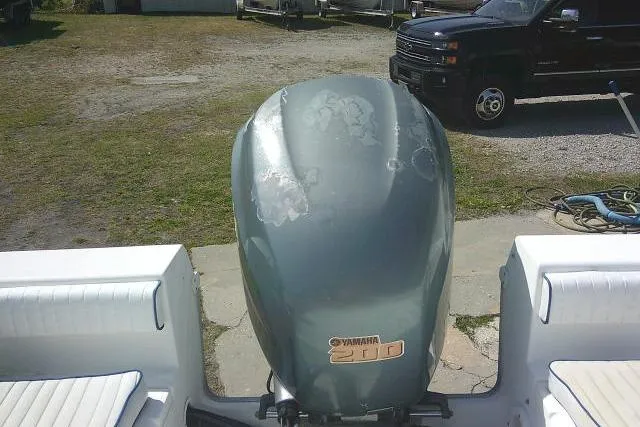 Slide: The Image of Outboard motor on a 2006 Clearwater 2200 Dual Console boat, parked outdoors. - 23