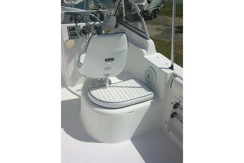 Slide: The Image of 2006 Clearwater 2200 Dual Console boat interior with steering wheel and seating. - 25