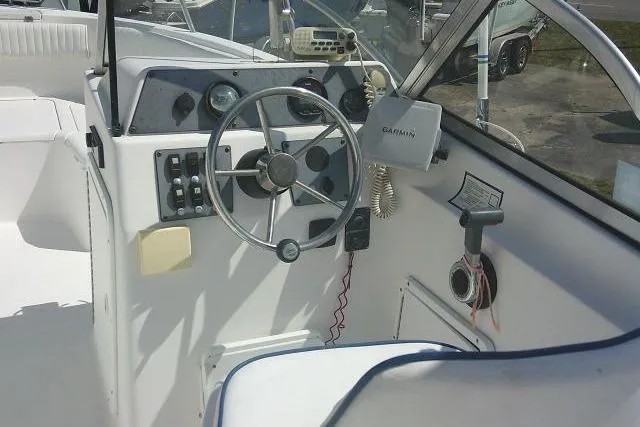 Slide: The Image of 2006 Clearwater 2200 Dual Console boat cockpit with steering wheel and Garmin device. - 26
