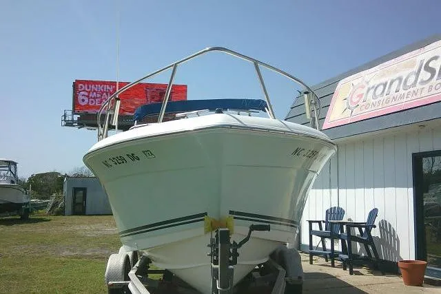 Slide: The Image of 2006 Clearwater 2200 Dual Console boat on trailer near consignment shop. - 3