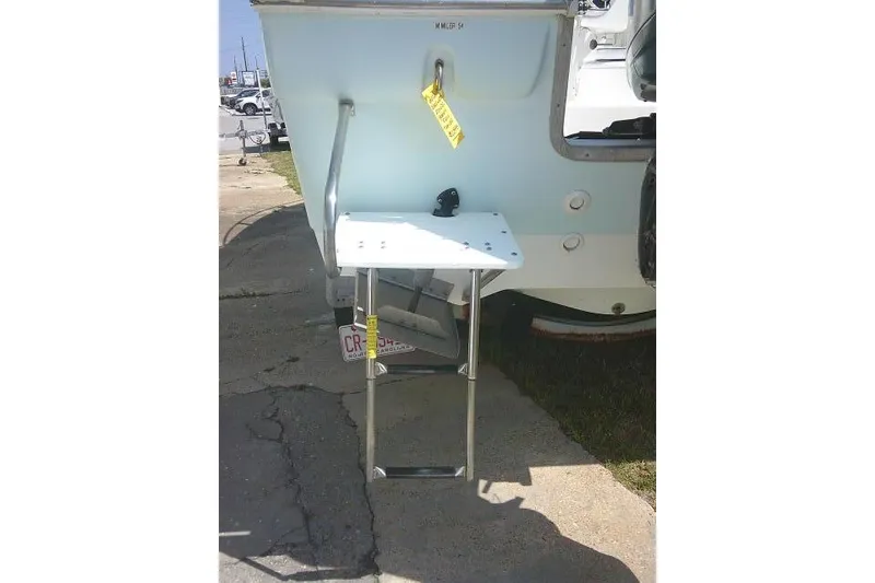 Slide: The Image of 2006 Clearwater 2200 Dual Console boat with foldable swim ladder and platform. - 7