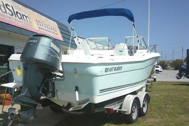 Slide: The Image of 2006 Clearwater 2200 Dual Console boat on trailer with outboard motor, parked outdoors. - 8