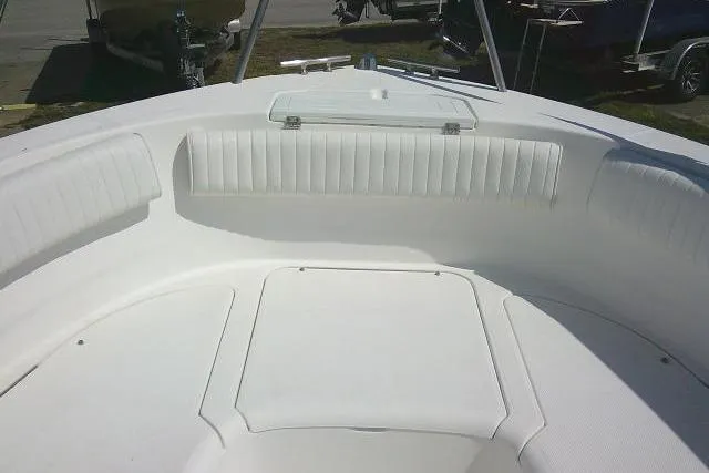 Slide: The Image of 2006 Clearwater 2200 Dual Console boat interior with white seating and storage compartment. - 9