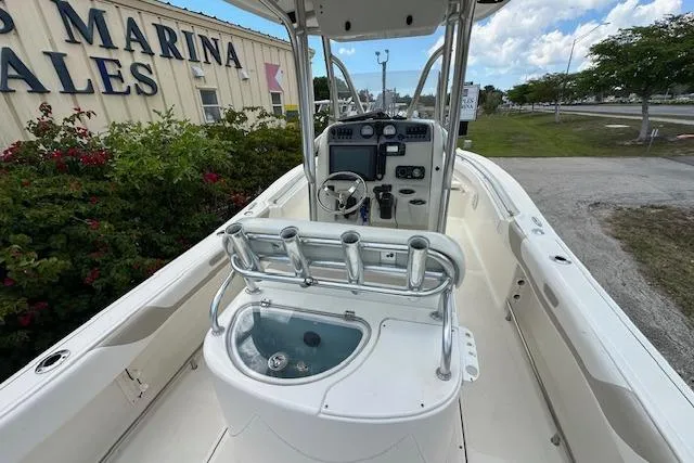 Slide: The Image of 2014 Pioneer 222 Sportfish boat interior with steering console and rod holders. - 10