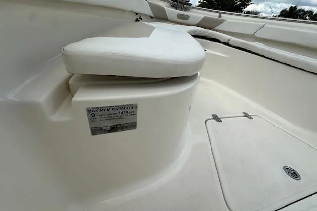 Slide: The Image of 2014 Pioneer 222 Sportfish boat interior with seating and capacity label. - 13