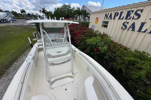 Slide: The Image of 2014 Pioneer 222 Sportfish boat docked near Naples Sales building. - 14