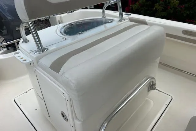 Slide: The Image of 2014 Pioneer 222 Sportfish boat interior with cushioned seating and storage compartment. - 16