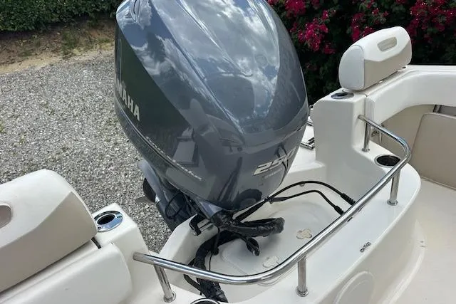 Slide: The Image of 2014 Pioneer 222 Sportfish boat with Yamaha outboard motor, rear seating, and stainless steel railing. - 17