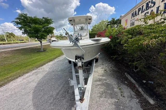 Slide: The Image of 2014 Pioneer 222 Sportfish boat on trailer, parked outdoors under a cloudy sky. - 25