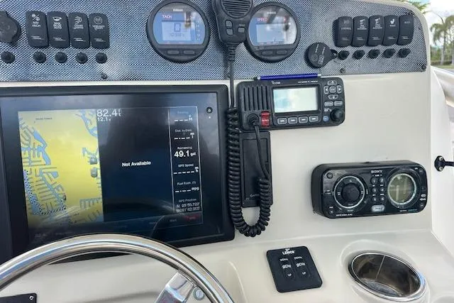 Slide: The Image of Dashboard of a 2014 Pioneer 222 Sportfish boat with navigation and communication equipment. - 3