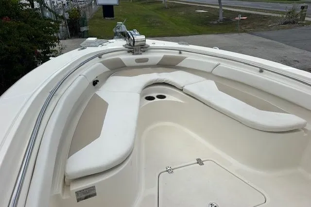 Slide: The Image of 2014 Pioneer 222 Sportfish boat with cushioned seating and storage compartments. - 5