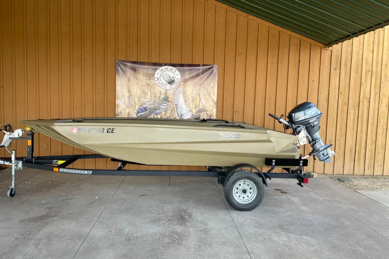 The Image of 2025 Edge Duck Boats 550 on trailer, displayed outdoors with wooden backdrop. - 0