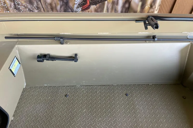 Slide: The Image of Interior of 2025 Edge Duck Boats 550, featuring rod holders and diamond-patterned flooring. - 14