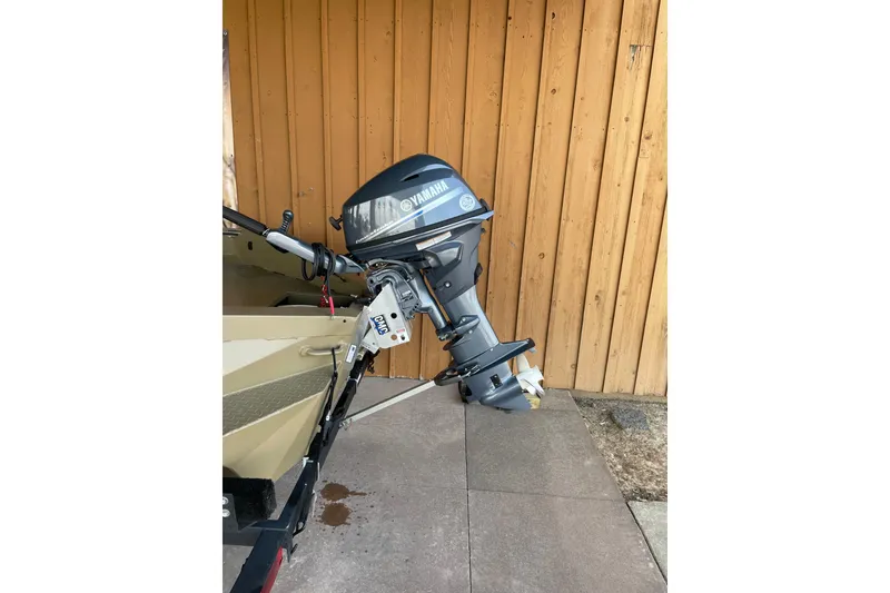 Slide: The Image of 2025 Edge Duck Boats 550 with Yamaha outboard motor, parked by wooden wall. - 8