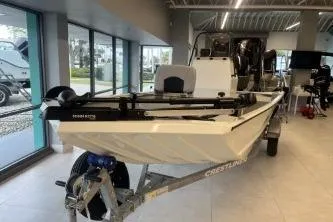 Slide: The Image of 2026 Crestliner 1860 Retriever CC boat displayed indoors on a trailer. - 4