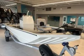 Slide: The Image of 2026 Crestliner 1860 Retriever CC boat displayed in a showroom on a trailer. - 5