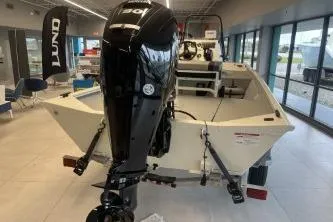 Slide: The Image of 2026 Crestliner 1860 Retriever CC boat with outboard motor in showroom. - 7