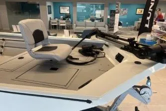 Slide: The Image of 2026 Crestliner 1860 Retriever CC boat interior with seating and controls in showroom. - 9