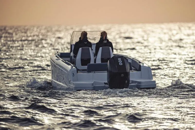 Slide: The Image of 2027 Axopar 22 Spyder cruising on open water at sunset. - 4