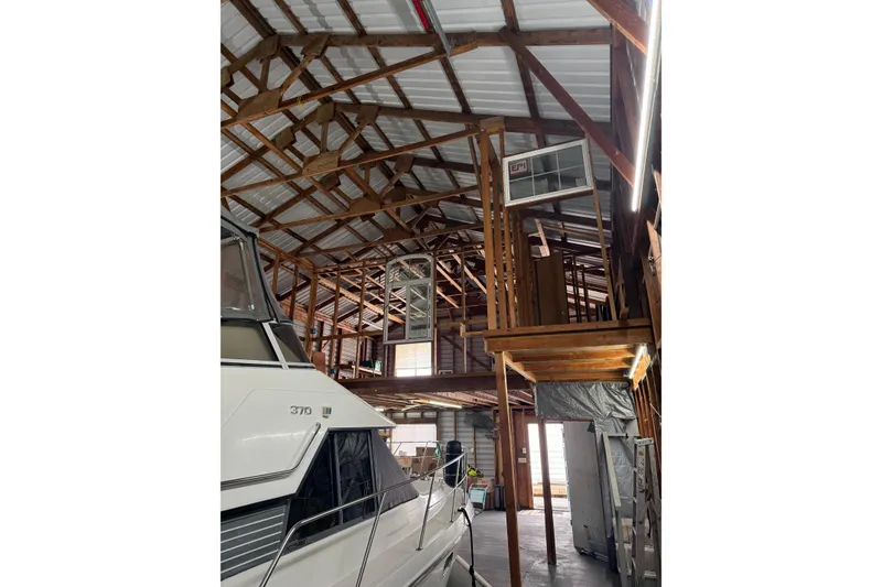 Slide: The Image of Interior of a wooden boathouse with a docked boat, Custom Hargraves model, 2008. - 2