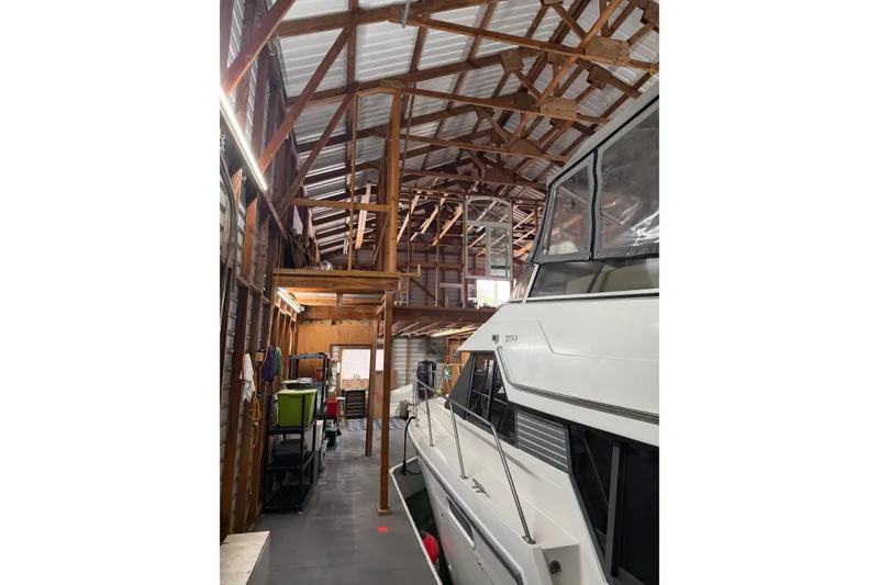 Slide: The Image of Interior of a wooden boathouse with a docked boat, Custom Hargraves model, 2008. - 3