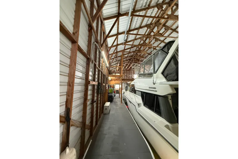 Slide: The Image of Interior of a wooden boathouse with a docked boat, Custom Hargraves model, 2008. - 4