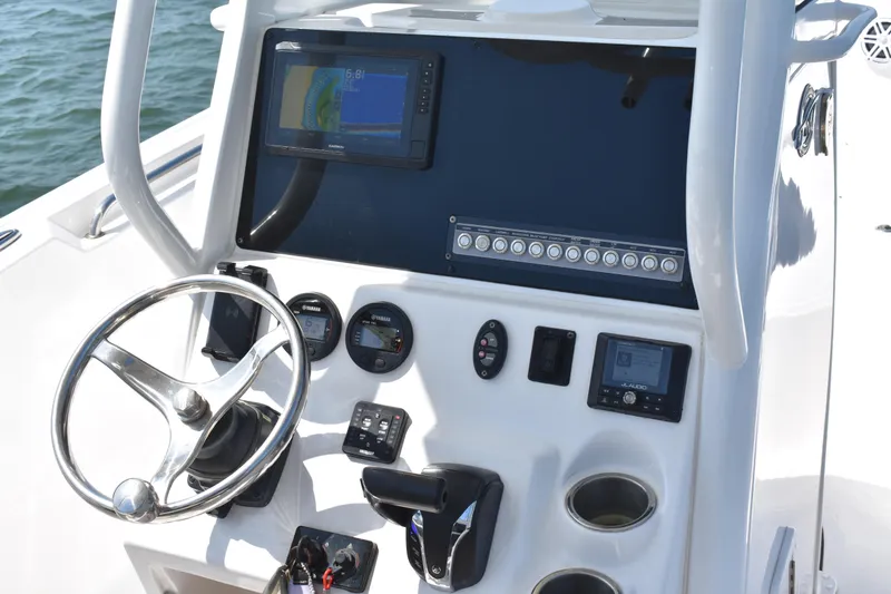 Slide: The Image of Center console of 2023 Tidewater 232 CC Adventure boat with navigation and control instruments. - 11