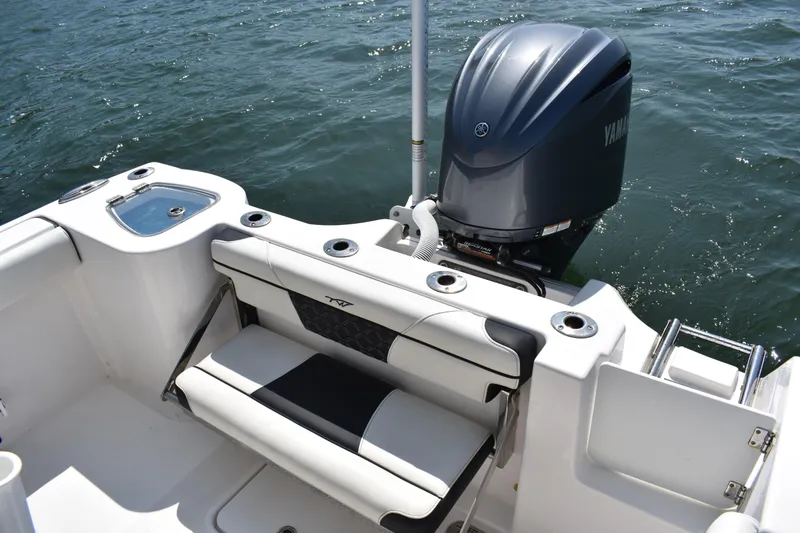Slide: The Image of 2023 Tidewater 232 CC Adventure boat with Yamaha outboard engine on water. - 17