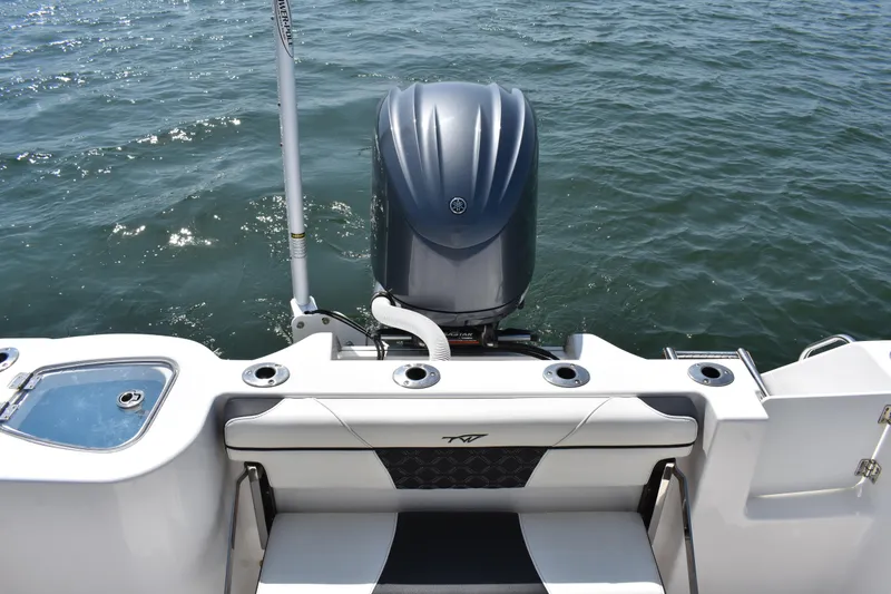Slide: The Image of 2023 Tidewater 232 CC Adventure boat with powerful outboard motor on open water. - 19