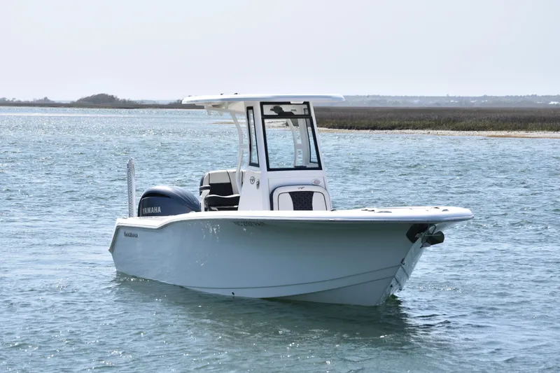 Slide: The Image of 2023 Tidewater 232 CC Adventure boat on calm water, featuring Yamaha engine. - 4