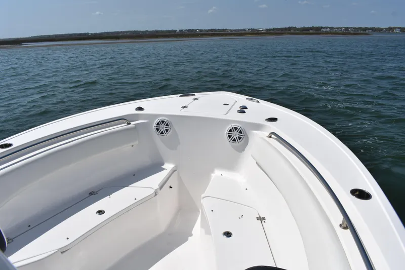 Slide: The Image of 2023 Tidewater 232 CC Adventure boat on calm water, showcasing spacious bow seating. - 6