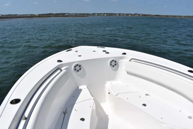 Slide: The Image of 2023 Tidewater 232 CC Adventure boat on calm waters, showcasing spacious deck and sleek design. - 7