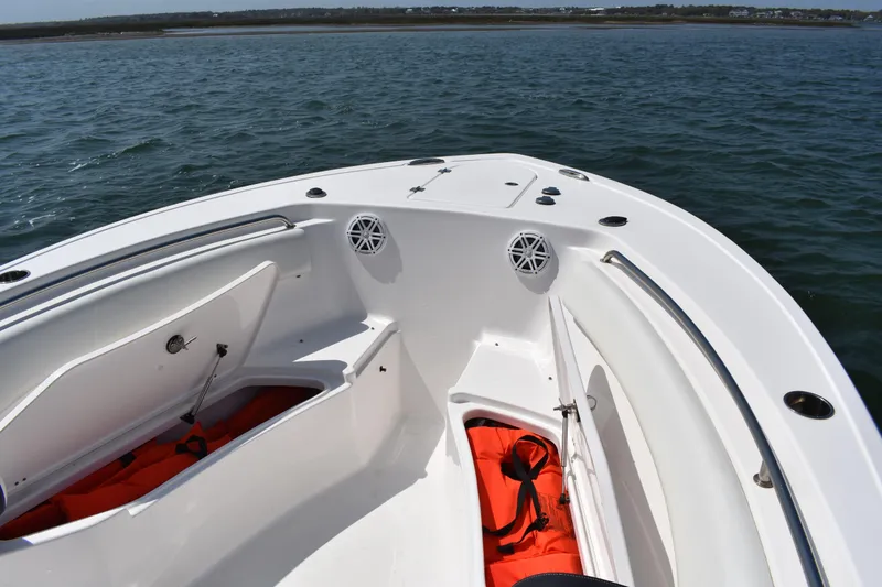 Slide: The Image of 2023 Tidewater 232 CC Adventure boat interior with storage compartments and life jackets. - 8