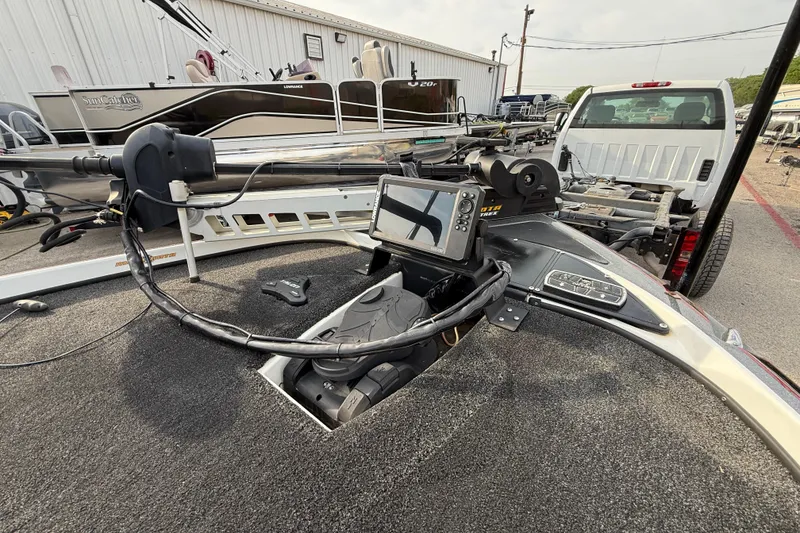 Slide: The Image of 2016 Nitro Z21 boat with advanced navigation system and trolling motor in a marina setting. - 16